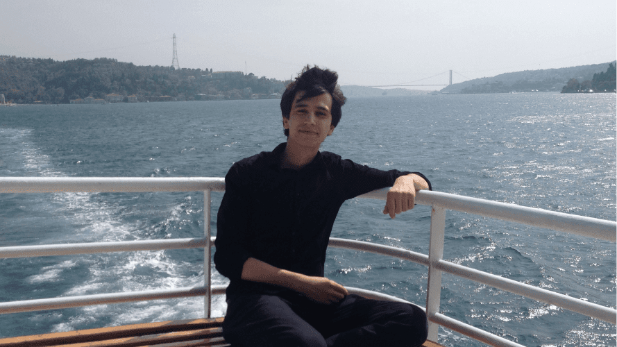 Man profile picture on a boat along a river