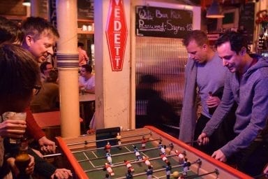 Team members playing table football